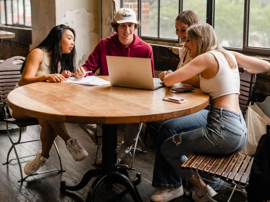 Students looking for housing online at a table in Ponce City Market