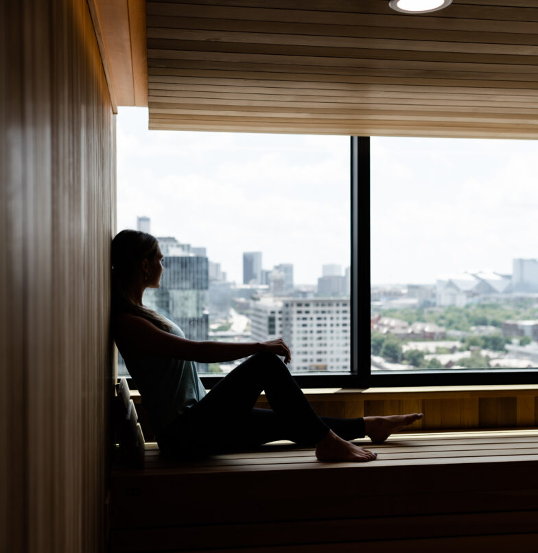 Girl looking over Downtown Atlanta from the Whistler sauna, student apartments in Midtown.