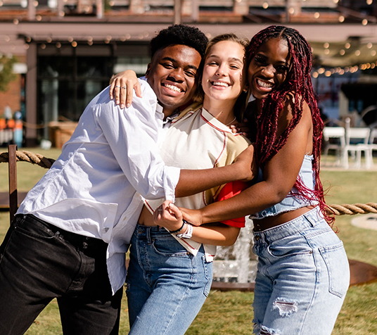 Friends hugging outside