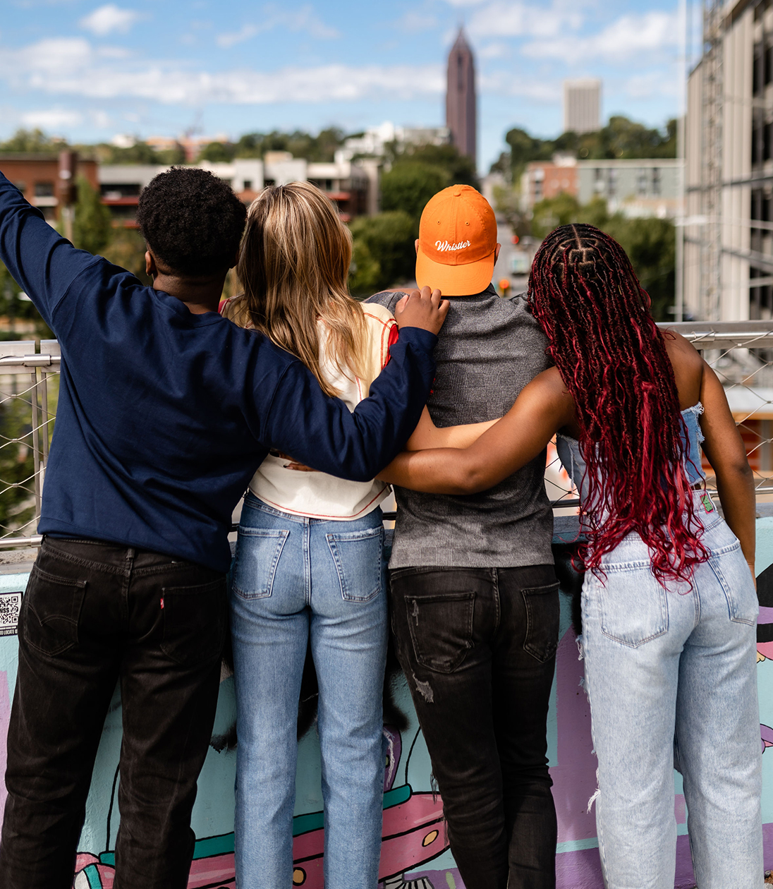 Friends hugging in front of a city view