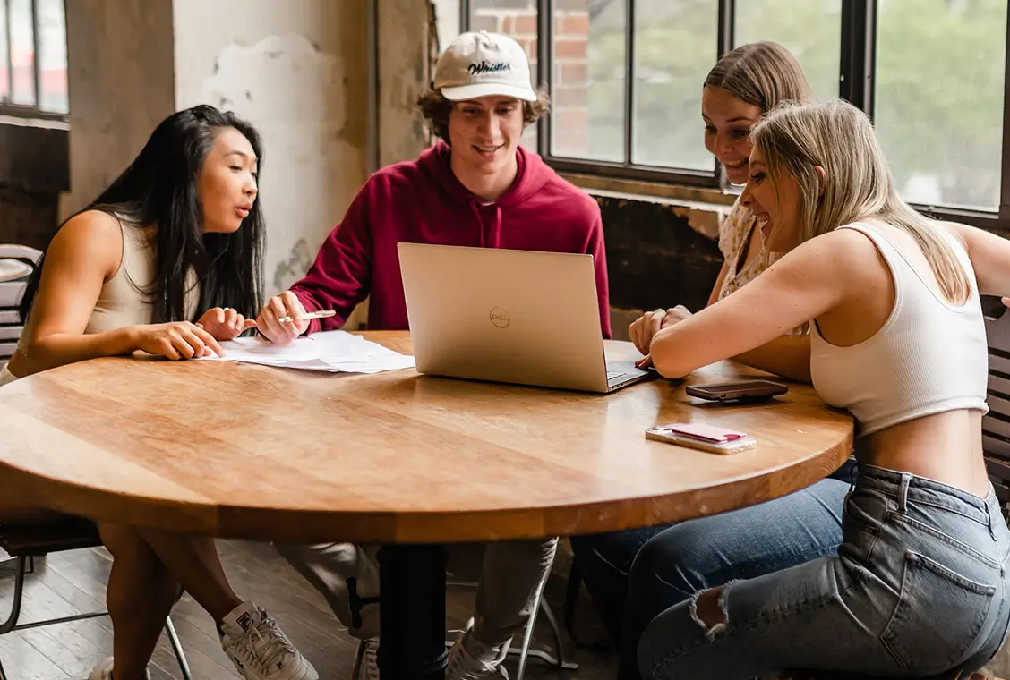 a group of residents looking at a laptop
